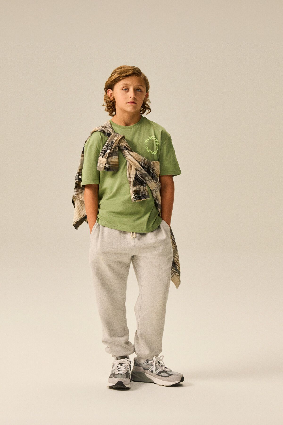 Child standing on a pile of books.