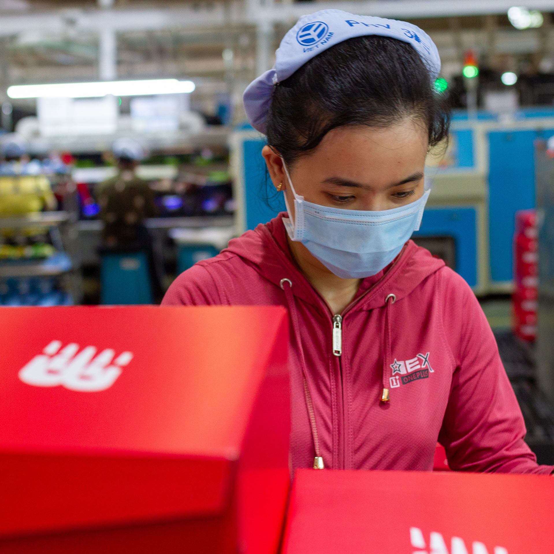 Female factory working packing shoe boxes