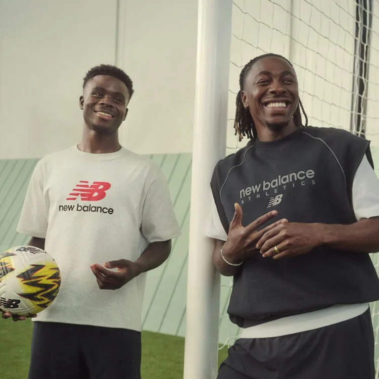 A group of soccer players standing on a soccer field. 