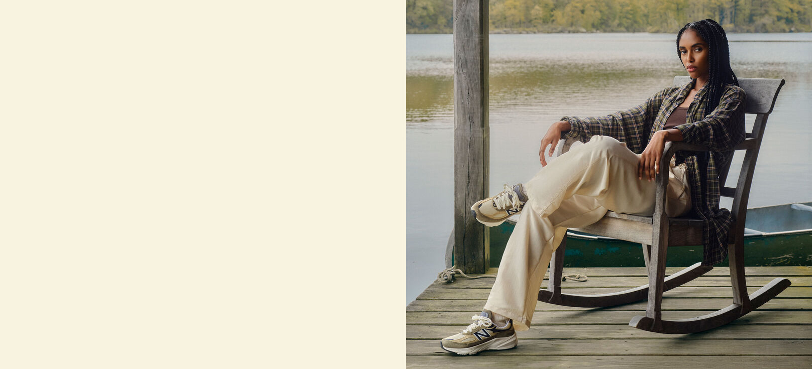 A woman sitting on a porch with a lake behind her. 